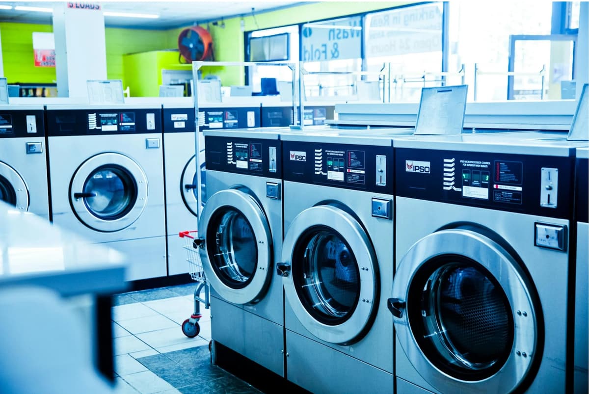 Professional technician servicing a washing machine drum